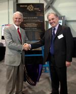 [Photo of TRIUMF Director Alan Shotter and Gordon Cambell with the ISAC-II Plaque.]